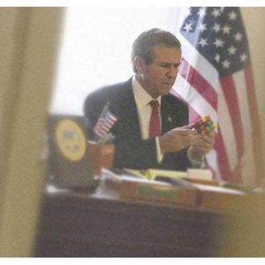 Bush with a Rubix Cube by Alison Jackson, lookalike of the former president playing with a rubix cube