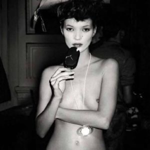 Kate Moss at Vivienne Westwood by Roxanne Lowit, the model topless in a pirate hat, eating icecream