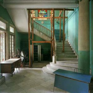 La Escuela Modela, 102 Calle 19, Vedado, Havana. 1997 by Robert Polidori, interior with columns, staircase and stainedglass windows, partially green walls