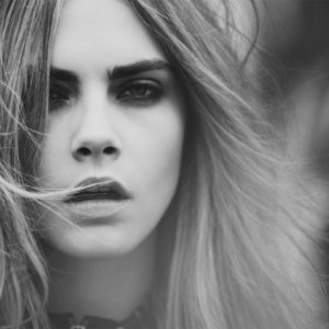 Cara Delevigne by Guy Aroch, black and whitre closeup portait of the model with messy loose hair
