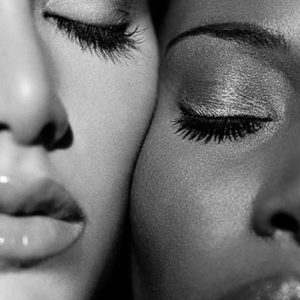 Carlota and N'Gone by Bruno Bisang, closeup portrait of two models pressing their faces together