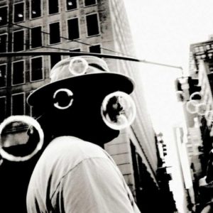 Bubbles, New York, 2011 by Andreas H. Bitesnich, man in hat on a NY crossroad with soap bubbles