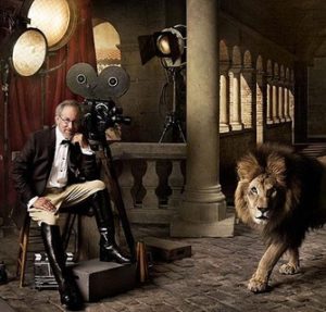 Steven Spielberg and Lion by Mark Seliger, the director in an antique architecture between film equipment, next to a lion