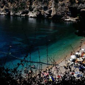 french riviera 2009 by Daid Drebin, beach, rocky cliffs and blue ocean through plants