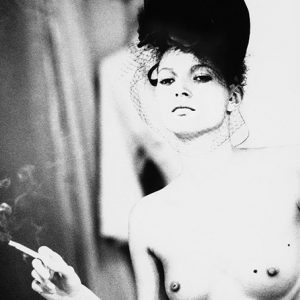 kate moss smoking by Ellen von Unwerth, the nude model with a black headpiece and face vei, holding a burning cigarette