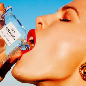 Thirsty by Tony Kelly, Model in red lip drinking from a broken Chanel No 5 bottle