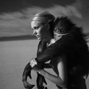 Beauty and Beast I 1996 by Michel Comte, Model and monkey piggyback in the desert