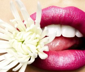 Chrysanthemum Bitten by Rankin, model with pink lips biting into a white flower
