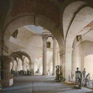 Les Petites Ecuries by Robert Polidori, antique stone arcs and columns with statues standing inbetween