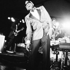Ray Charles, New York by Roxanne Lowit, the singer in a suit performing on stage