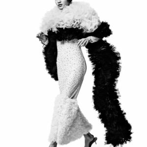 Chiharu Okunugi - Vogue Japan - New York City 2019 by Albert Watson, model jumping in white rhinestone and ruffle dress with black ruffle boa