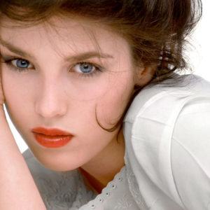 Isabelle Adjani - Mademoiselle - New York City 1975 by Albert Watson, portrait of the french actress in a shite shirt and red lip