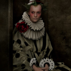 Lina - New York City 2017, model sitting in black and white clown costume with red fabric flower and green hair