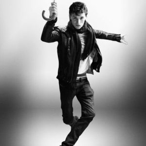 Eddie Redmayne by Alison Jackson, lookalike of the actor jumping with an umbrella