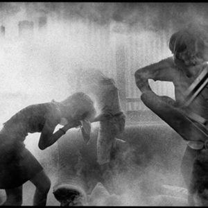 Tower Block by Alison Jackson, children in a living room, surrounded by dust, one throwing a chair