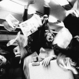 Train by Alison Jackson, people in a train screaming while newspaper are flying around