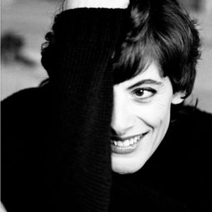 Inès de le Fressange by Gérard Uféras, portrait of the model with short hair, wearing a black knitsweater