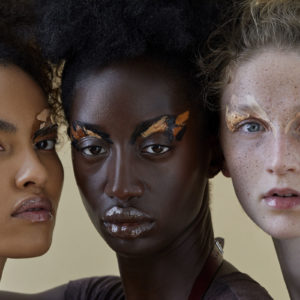 What is Beauty by Iris Brosch, closeup portrait of three model with different skintones and abstract skin toned eye makeup