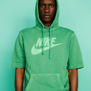 Untitled IX by Marc Baptiste, portrait of male model wearing a green nike sweater in front of a green background