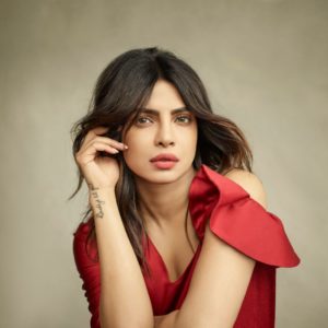 Priyanka Chopra by Mark Seliger, portrait of the actress in a red dress or shirt