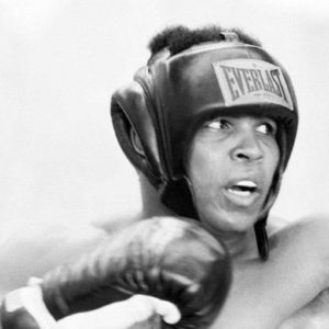 Muhammad Ali by Terry O'Neill, black and white portrait of the boxer with his gear on