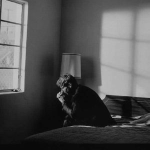 Harrison Ford by Timothy White, the actor sitting on a bed in front of a window