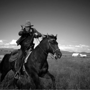 Harrison Ford 2010 by Timothy White, the actor with cowboyhat and pisto, on a horse