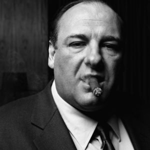 James Gandolfini by Timothy White, black and white portrait of the actor in a dark suit smoking a cigar