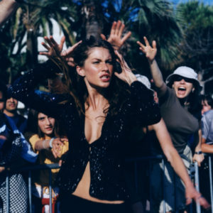 Gisele Bundchen Paparazzi by Michel Comte, the model in glitter cardigan between fans