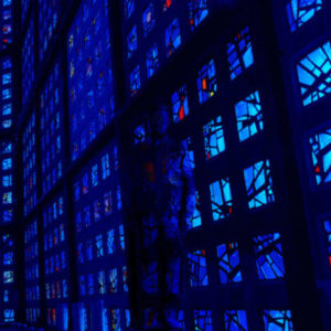 Hiding in Germany by Liu Bolin, blue and red stained glass windows