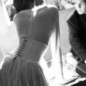 Naomi Campbell and Azzedine Alaia, Paris 1986 by Arthur Elgort, the model in white with corset from the back