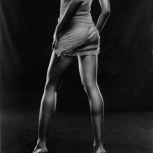 Nathaly Milan by Bruno Bisang, the model from the back in short dress and heels, b&w