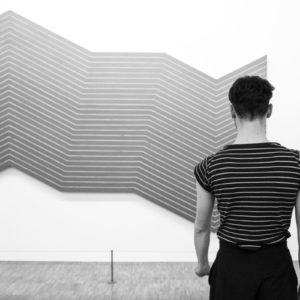 Musée national d'art moderne - Centre Pompidou by Gérard Uféras, figure in striped shirt in front of abstract art