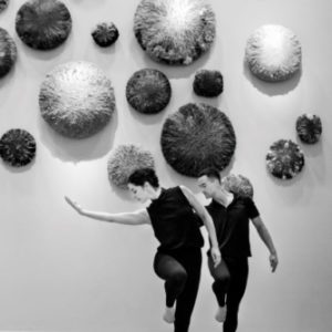 MAM vile de Paris by Gérard Uféras, two dancers in black in front of awallinstallation