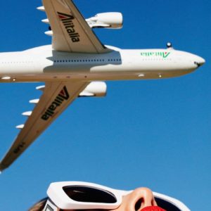 Diretto per Roma by Tony Kelly, Woman in Versace Sunglasses and Red Lip with air plane