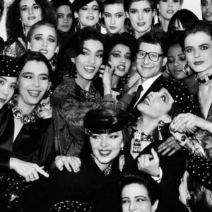 Yves Saint Laurent with Models by Roxanne Lowit, black-and-white fine art photography showing the designer surrounded by models