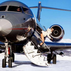 Tony Kelly Jet Set 2024, model skiing down the entry stairs of a private jet in the swiss alps