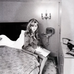 Unwerth Kate Moss Reading US Vogue, supermodel sitting on a bed