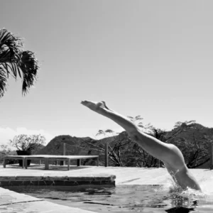 Antoine Verglas Ivory Rose Strzalkowski, Antoine Verglas photography, black and white nude art photo, artistic nude in nature, fine art nude photography, female form in motion, contemporary black and white photo, fine art nude diving into pool, black and white artistic nude of woman, luxury lifestyle fine art image