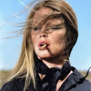 Brigitte Bardot by Terry O'Neill, black and white portrait of the actress in black blouse and scarf, hair blowing in the wind, smoking a cigarette